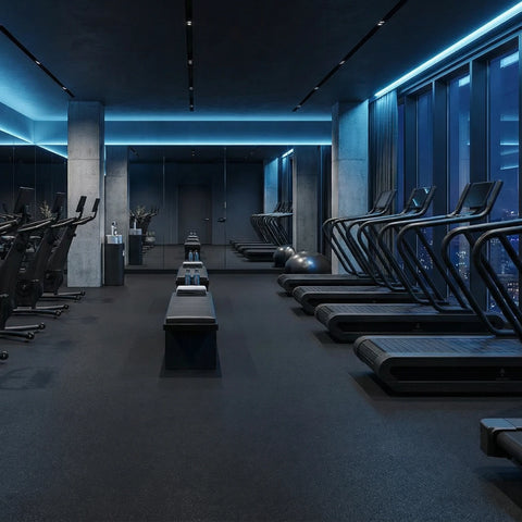 A modern gym interior with rows of NOHRD Citius treadmills and Bikes in a dark, high-end fitness space with blue ambient lighting and large windows overlooking a city skyline.